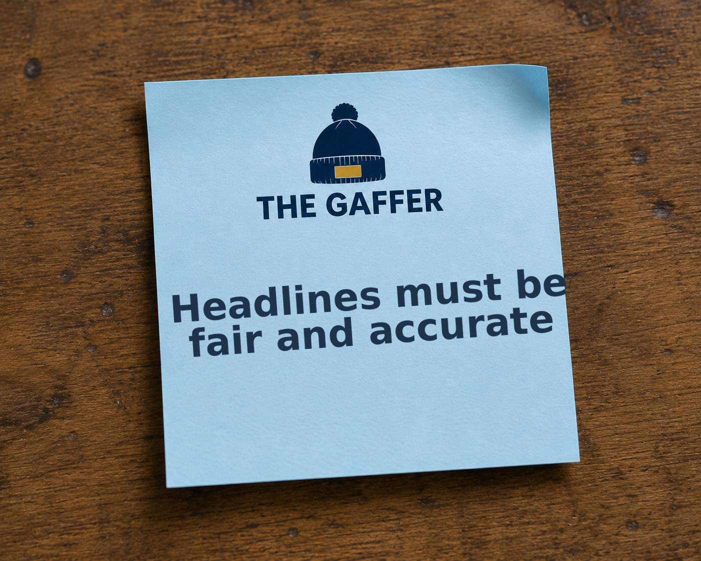 Light blue Post-it note on a wooden desk, headed with The Gaffer bobble-hat logo, reading: Headlines must be fair and accurate.