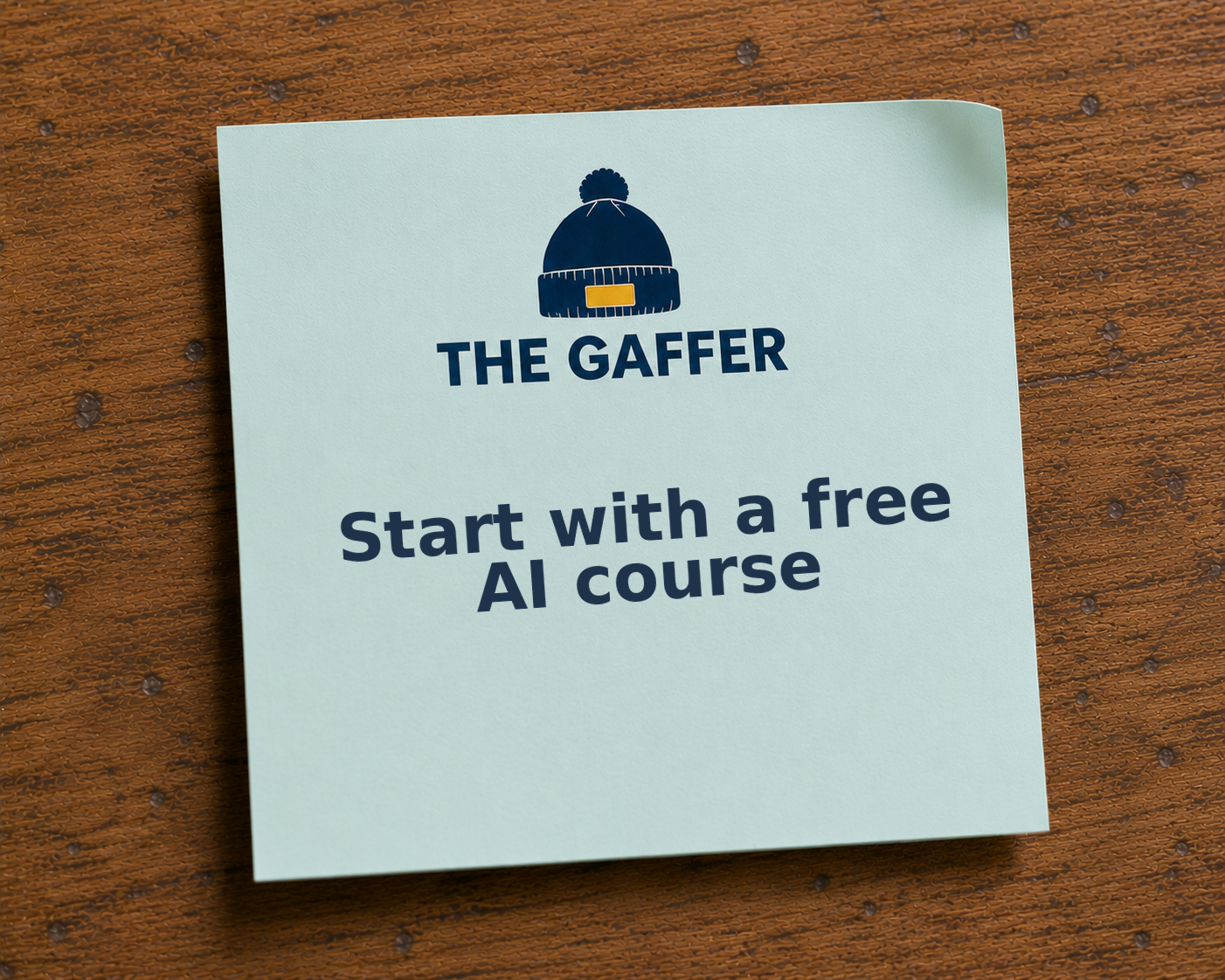 Light blue Post-it note on a wooden desk, headed with The Gaffer bobble-hat logo, reading: Start with a free AI course.